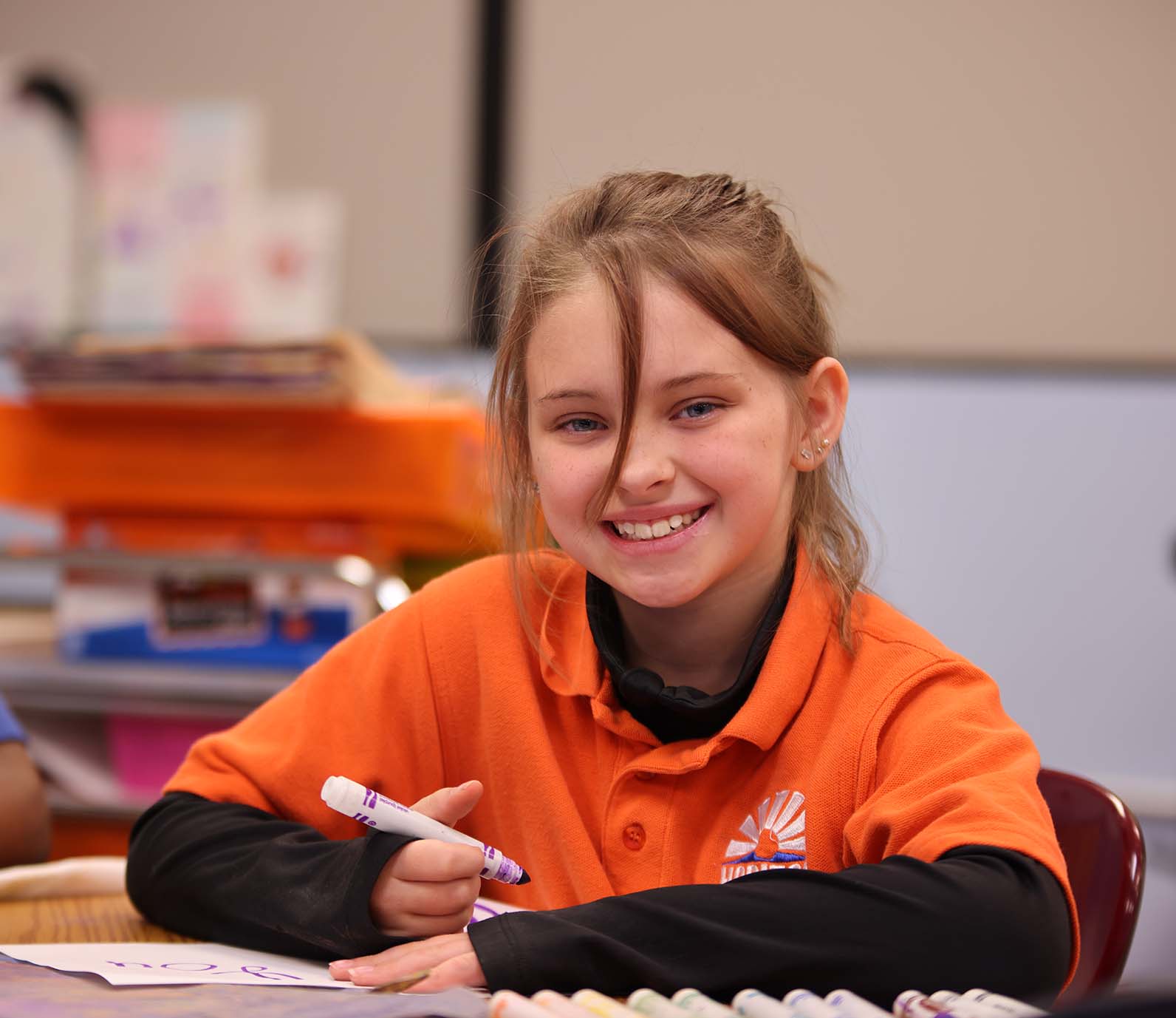Horizon Science Academy of Lorain student wearing headphones uses a laptop in class