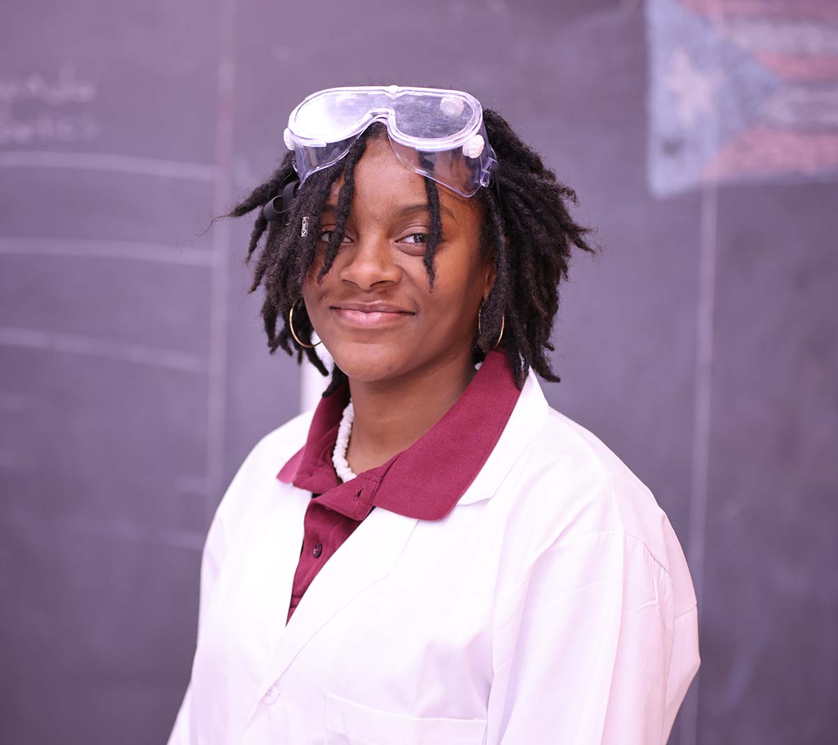 Student working on a notebook in a classroom.